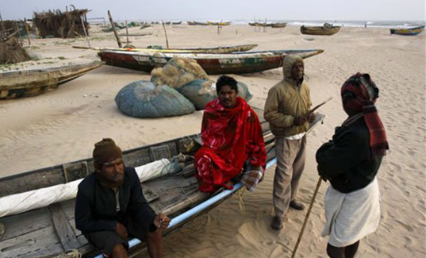 Fishermen sit idle on an anchored fishing boat waiting for developments after a cyclone alert at Kalingapatnam, in the southern Indian state of Andhra Pradesh on Thursday. AP Fishermen sit idle on an anchored fishing boat waiting for developments after a cyclone alert at Kalingapatnam, in the southern Indian state of Andhra Pradesh on Thursday. AP